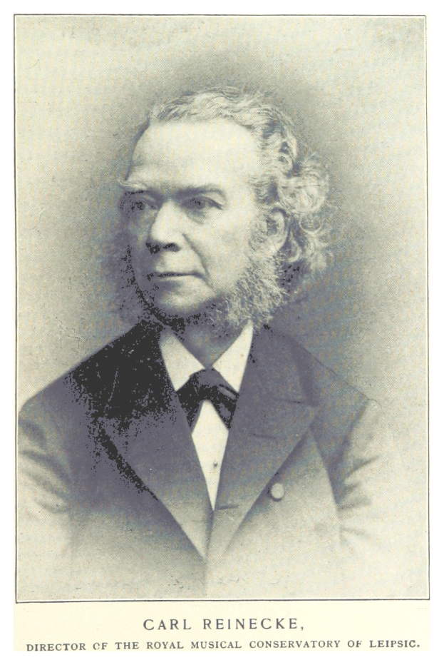 Schwarzes und weißes Foto von Carl Reinecke, Direktor des Königlichen Musikalischen Konservatoriums Leipzig, der einen Anzug trägt, mit Text unten im Bild.