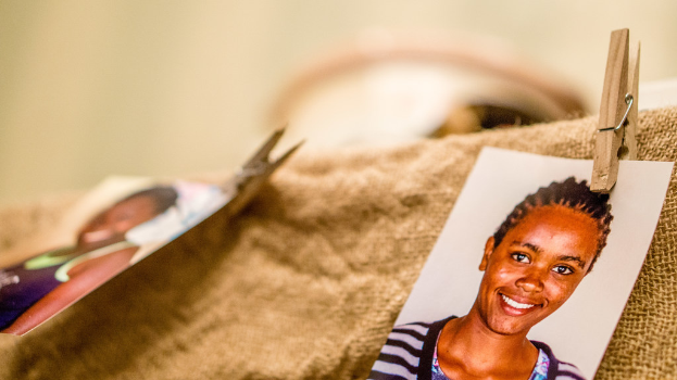 Auf dem Tisch liegt eine Klammer, ein Passfoto und ein Stoffstück auf der rechten Seite, mit einem unscharfen Hintergrund und linker Seite.